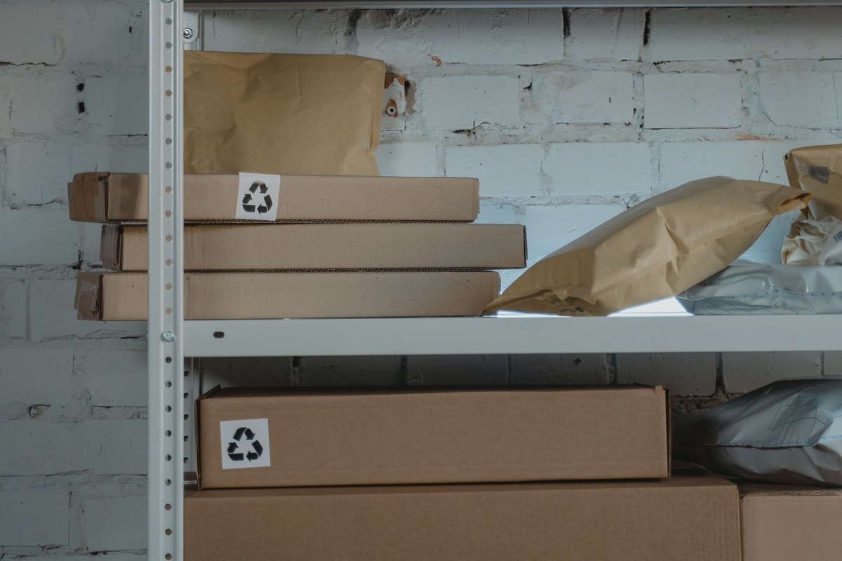 Cardboard boxes with fragile labels on industrial shelving