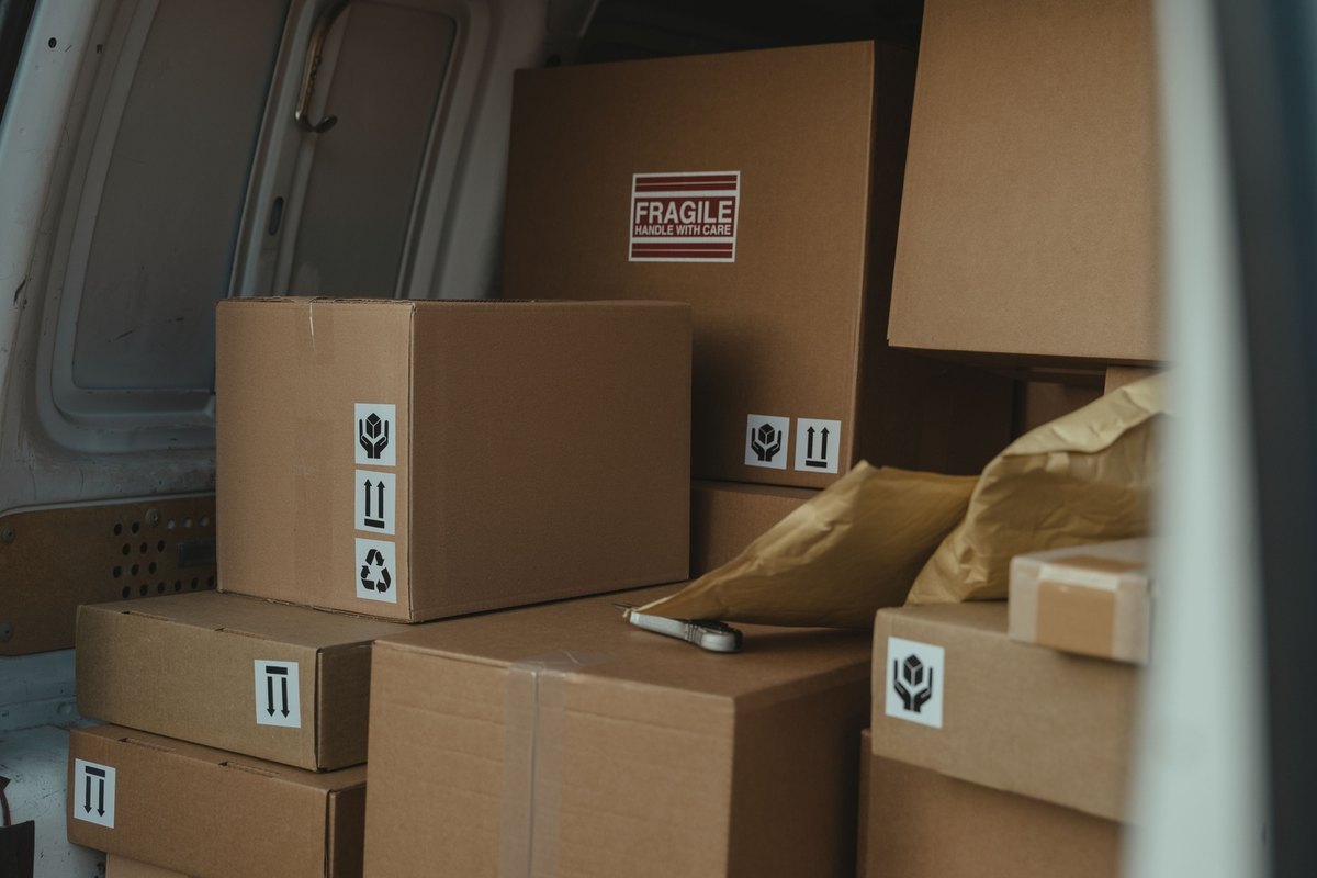 Parcels and padded envelopes stacked inside a delivery van